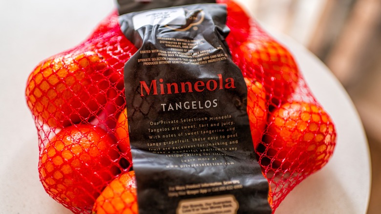 Minneola tangelos citrus fruit sweet fruits food in mesh net bag with Private Selection kroger brand sign label