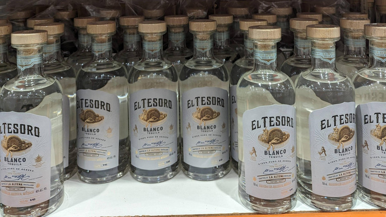 Rows of El Tesoro Blanco tequila bottles on a Costco shelf.