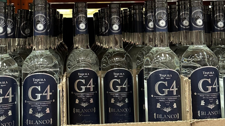 Rows of bottles of G4 Tequila Blanco on a shelf at Costco