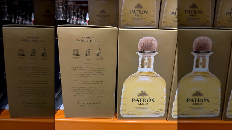 A row of Patron tequila boxes on shelves at a Costco.