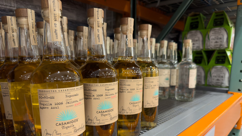 Several bottles of Casamigos are lined up on a Costco shelf.