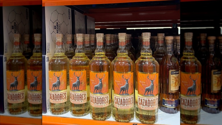 Rows of bottles of Cazadores tequila on Costco shelf