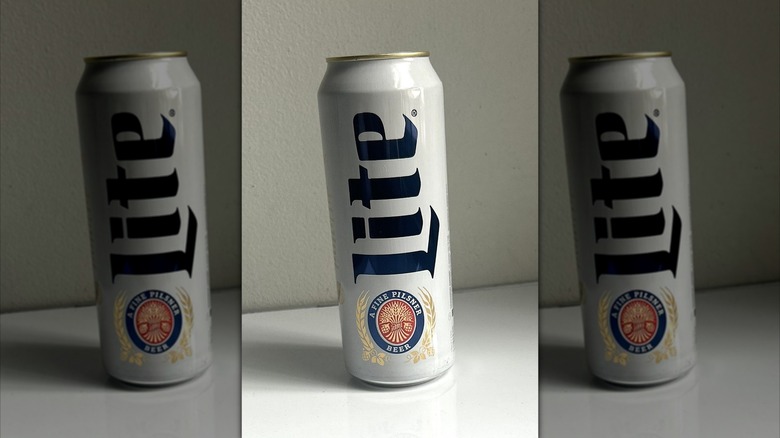 Tall can of Miller Lite beer on a white background on table, mirrored