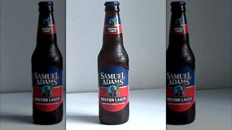 Bottle of Samuel Adams lager on a white background on table, mirrored