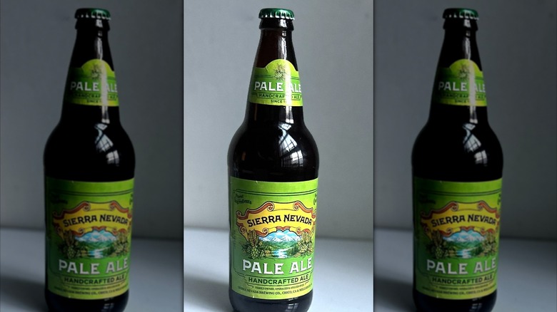 Bottle of Sierra Nevada pale ale on a white background on table, mirrored