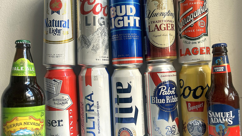 Numerous classic American beers displayed in rows, including Coors, Bud Light, Pabst Blue Ribbon