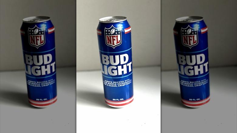 Tall can of Bud Light beer on a white background on table, mirrored