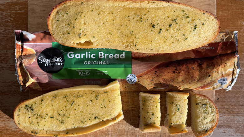 Albertsons half garlic bread loaf on its bag above a few individual slices