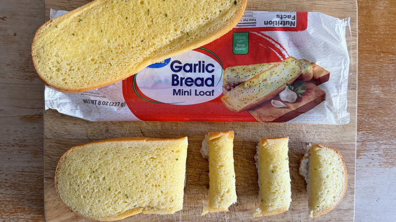 Walmart half garlic bread loaf on its bag beside a few individual slices