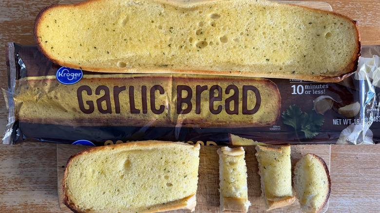 Kroger half garlic bread loaf on its bag above a few individual slices