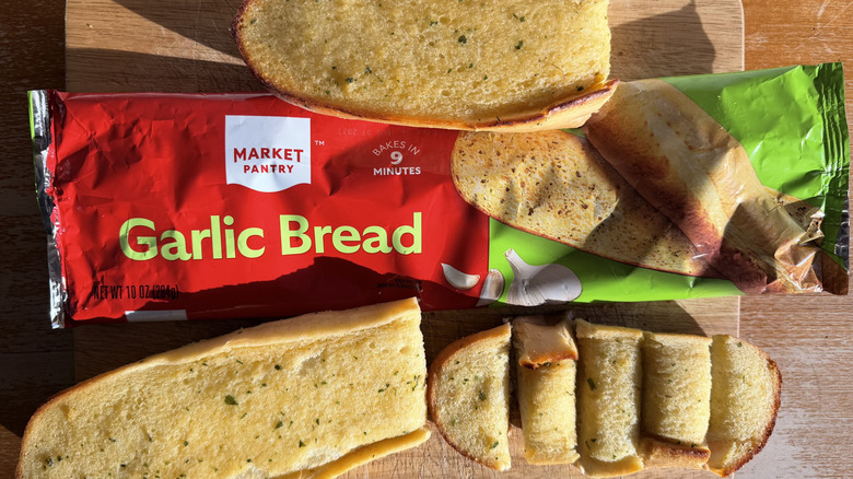 Market Pantry half garlic bread loaf on its bag above a few individual slices