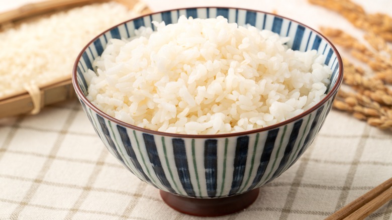 A bowl of freshly cooked steamed white rice on a table