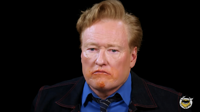 Conan O'Brien covered in hot sauce on "Hot Ones"