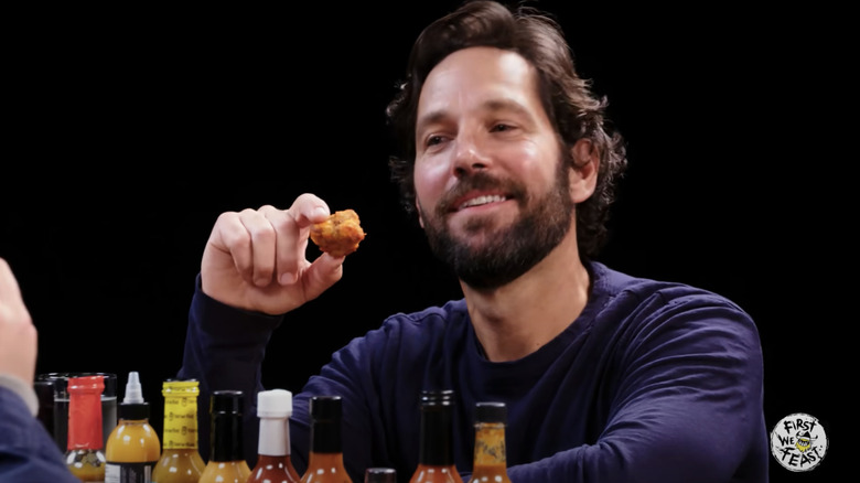 Paul Rudd smiling in the face of Da' Bomb hot sauce