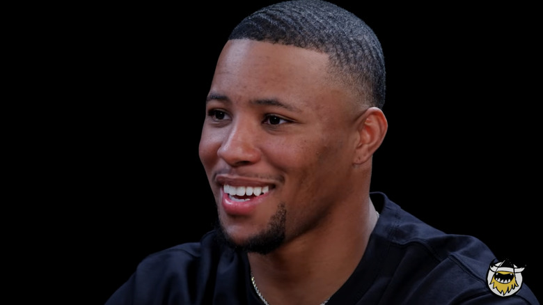 Saquon Barkley smiling while talking with host Sean Evans