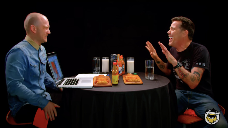 Sean Evans and Steve-O laughing together on "Hot Ones"