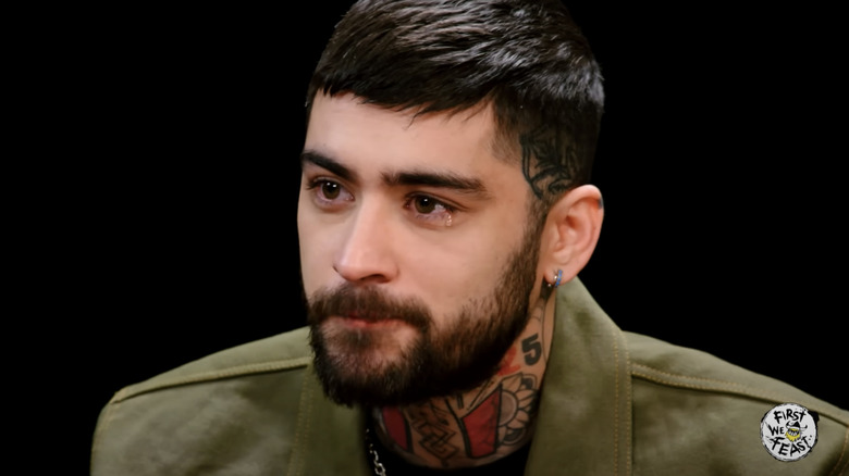 Zayn Malik letting a tear slip after eating Da' Bomb hot sauce