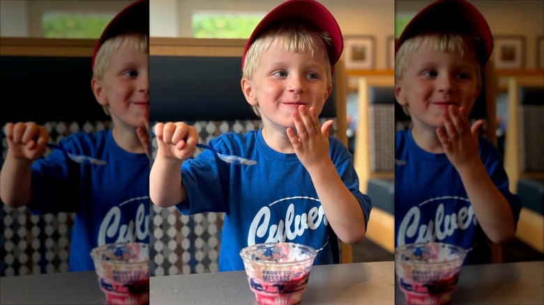 Kid inside culvers restaurant eating custard from a dish