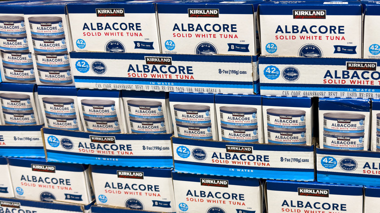 Multiple boxes of Costco Kirkland Signature albacore canned tuna stacked on top of each other.