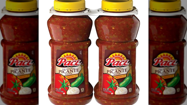 two bottles of picante sauce with yellow caps