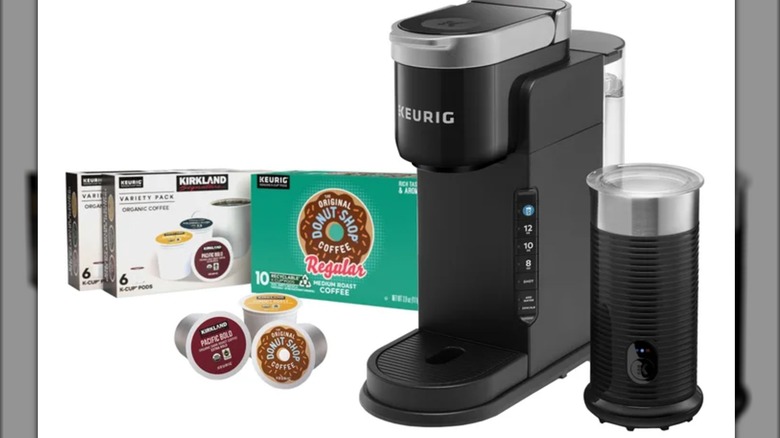 Keurig K-Cafe Barista coffee maker next to two boxes and three loose K-cups