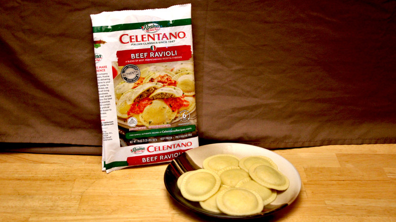 A cooked plate of Celentano brand Beef Ravioli placed beside the bag it came in