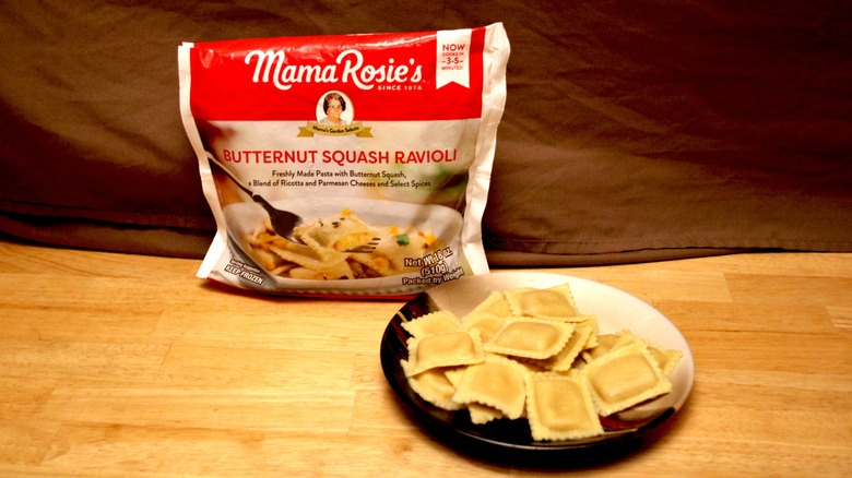 A cooked plate of Bettergoods brand Butternut Squash Ravioli placed beside the bag it came in
