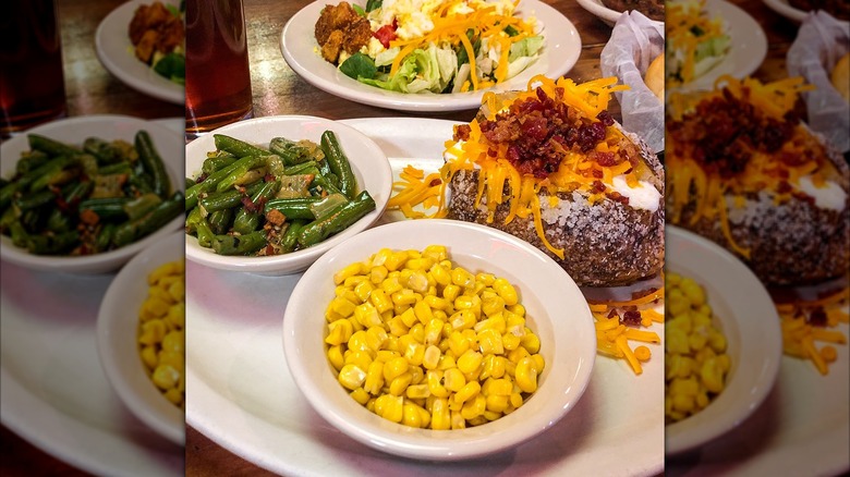 Salad, baked potato, green beans, and corn