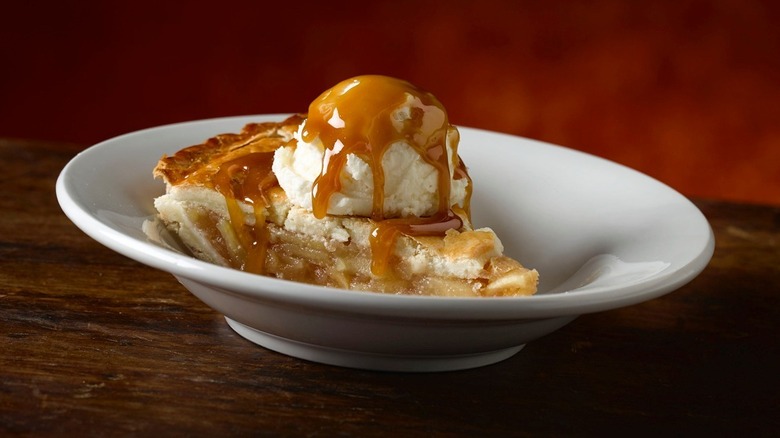 Apple pie covered in ice cream and caramel