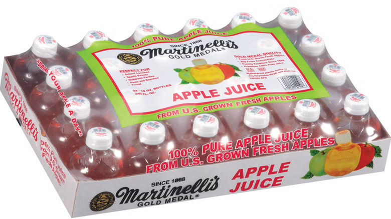 A package of plastic bottles of Martinelli's Gold Medal Apple Juice on a white background.