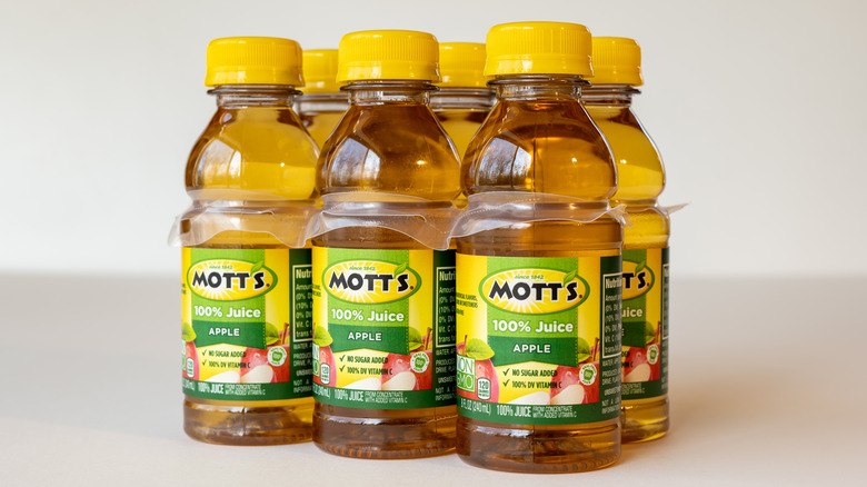 multiple bottles of Mott's 100% Apple Juice on counter
