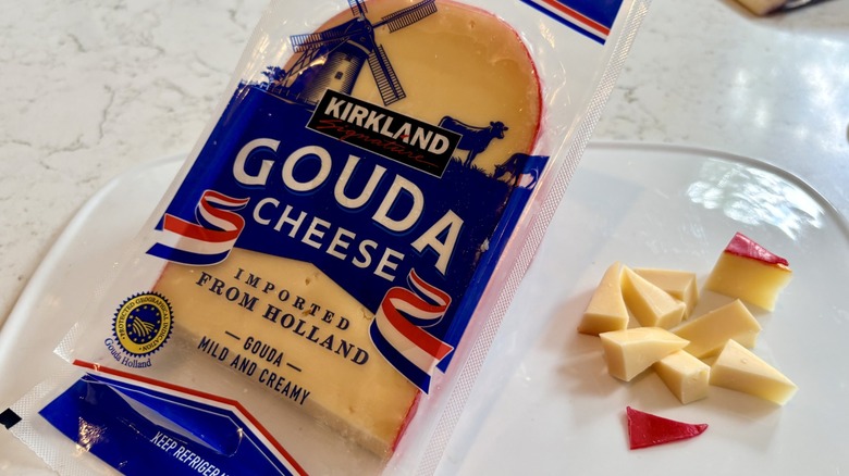 Big wedge and bites of Kirkland Signature imported Gouda cheese on a platter