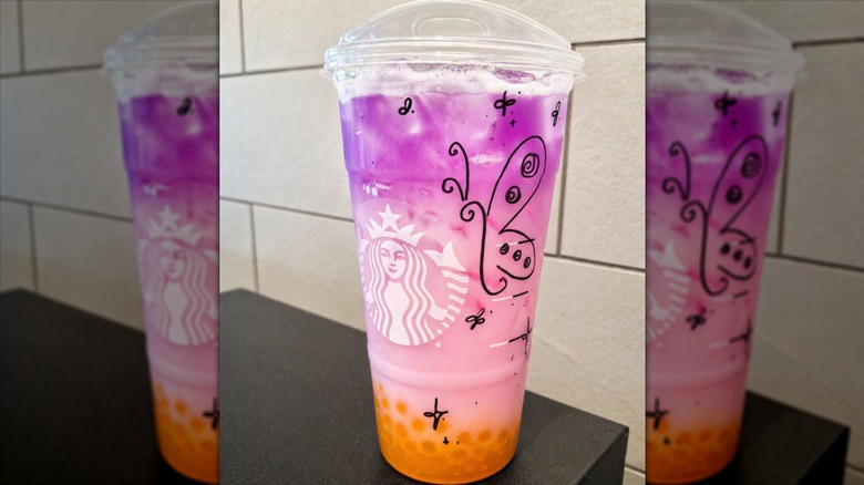 Tropical Butterfly Refresher from Starbucks in a decorated cup.
