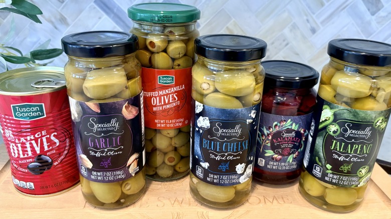 An assortment of jar and can olive varieties found at Aldi