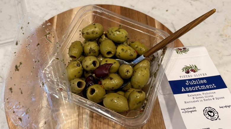 An open container of Aldi Jubilee Assortment refrigerated olives