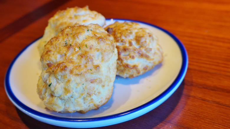 Three Cheddar Bay biscuits on a plate.