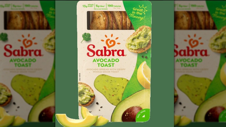 Box of Sabra avocado toast on a green background