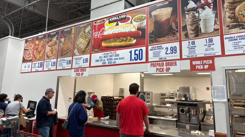 Customers standing at the counter of Costco's food court