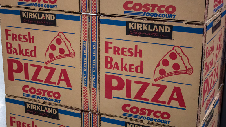 Stacks of the to-go boxes that Costco's whole pizzas come in