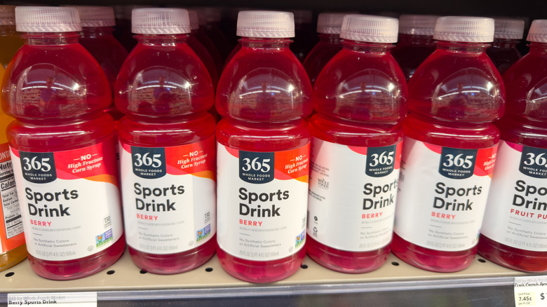 Bottles of red colored 365 Sports Drink on a store shelf