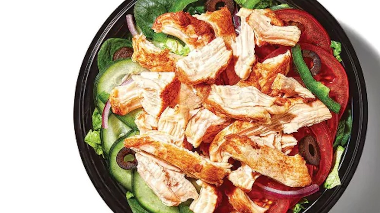 Rotisserie Chicken Protein Bowl in black plastic bowl on white backdrop