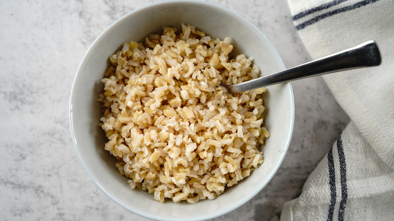 Brown rice in a bowl with fork
