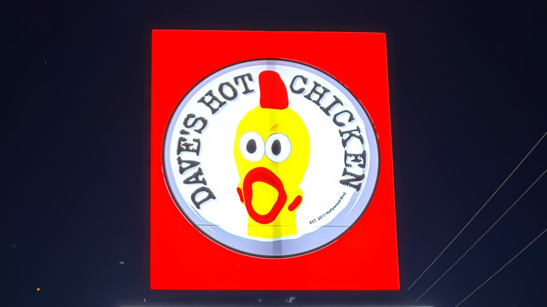 A sign for Dave's Hot Chicken, night