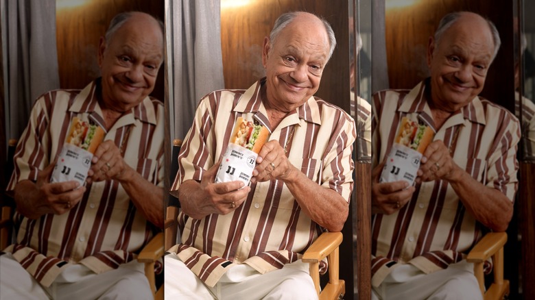 Cheech Marin holding a Jimmy John's sandwich, mirrored