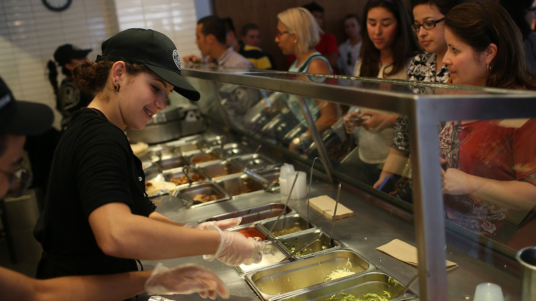 Chipotle staff putting orders together for customers in line