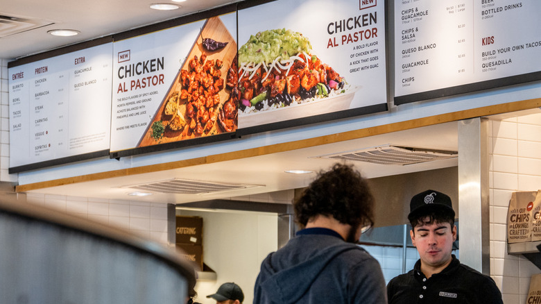 A customer buying food at Chipotle