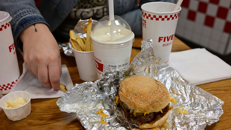 Someone eating a meal at Five Guys