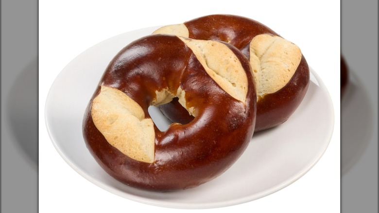 Two Kirkland Signature Pretzel Bagels on white plate on white background