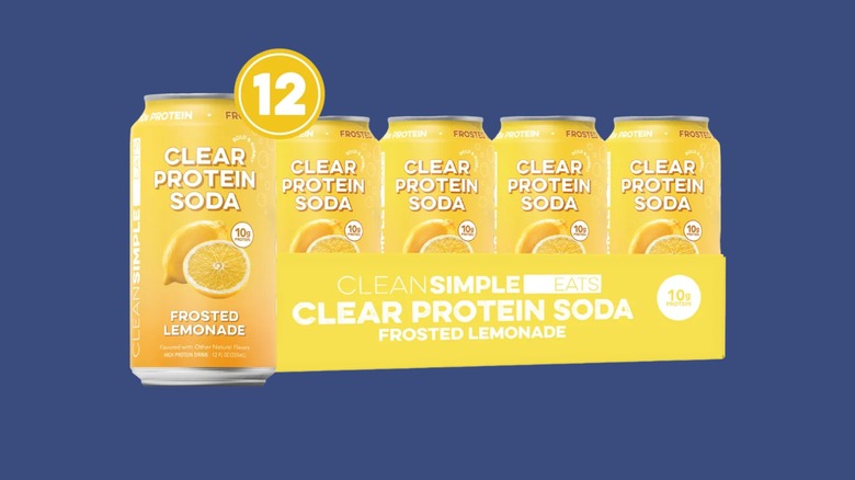 Cans of the Clean Simple Eats Frosted Lemonade Clear Protein Soda sold at Costco on a blue background.