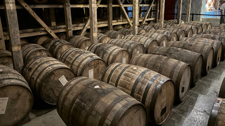 Rows of wooden barrels aging in a warehouse